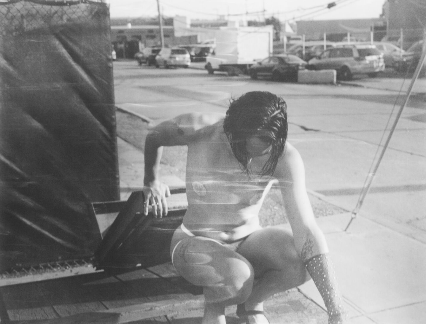 Black and white picture of a person in a car park